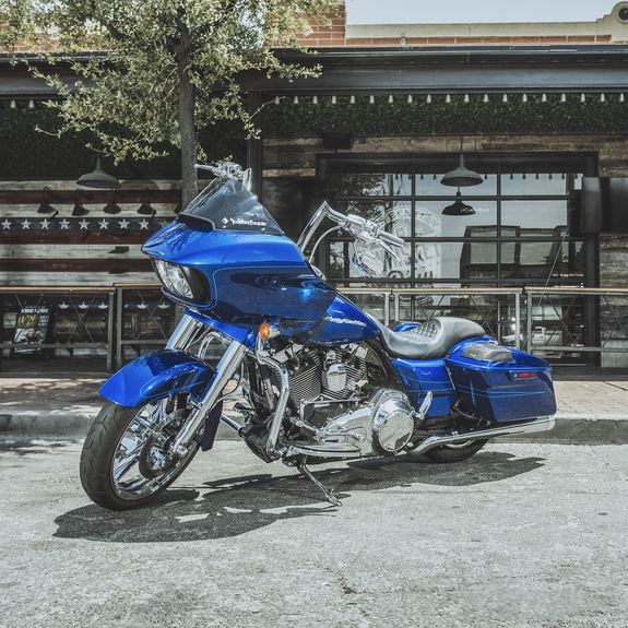 Profile View of Motorcycle Parked on Pavement